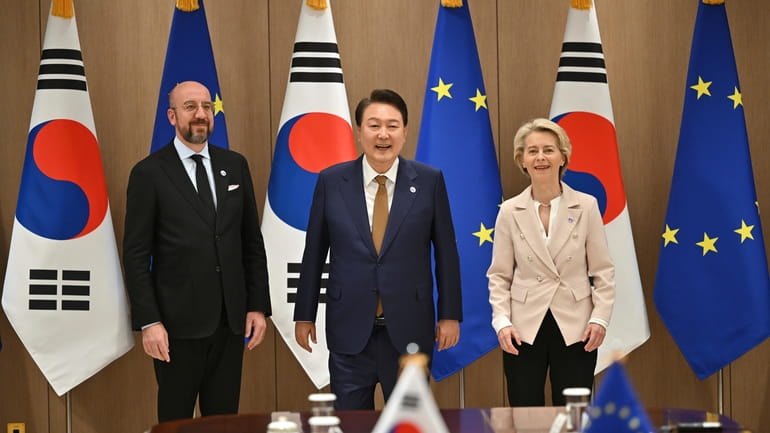 South Korea's President Yoon Suk Yeol, center, poses for a...