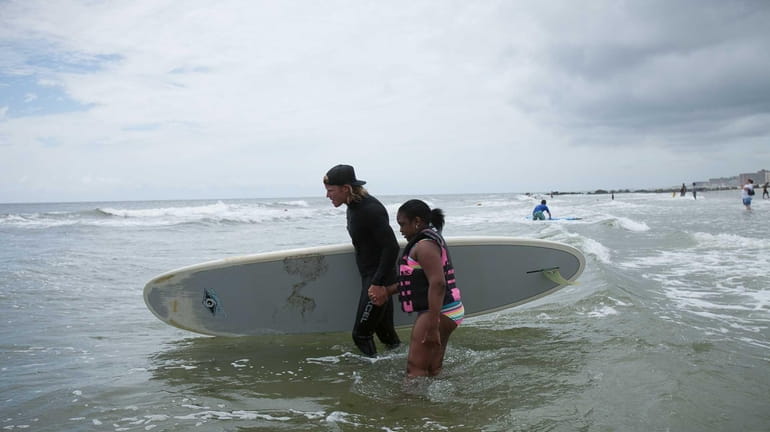 Tamika Thompson, 11, learns to surf with a Skudin Surf...