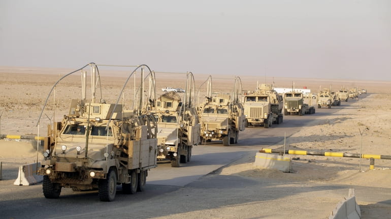The last vehicles in a convoy of the U.S. Army's...