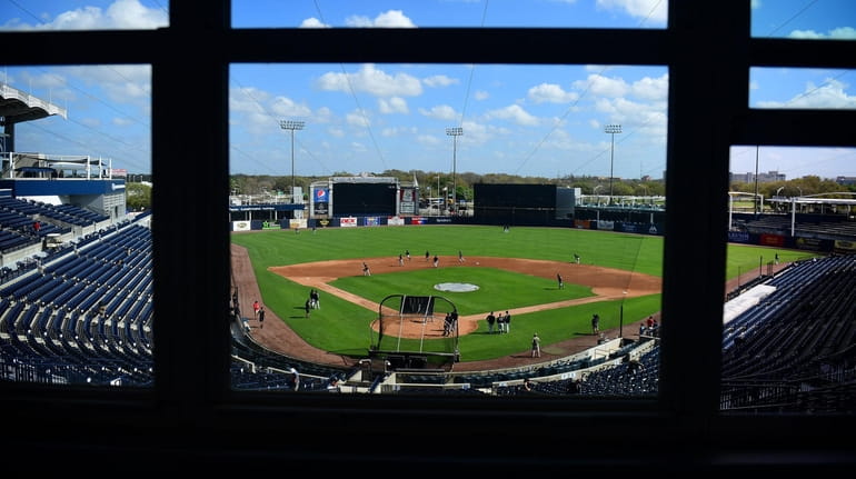 Yankees players work out before a spring training game at George...