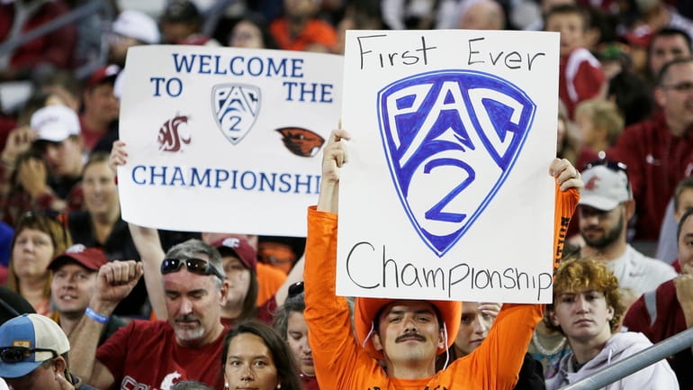 An Oregon State fan, front, and a Washington State fan...