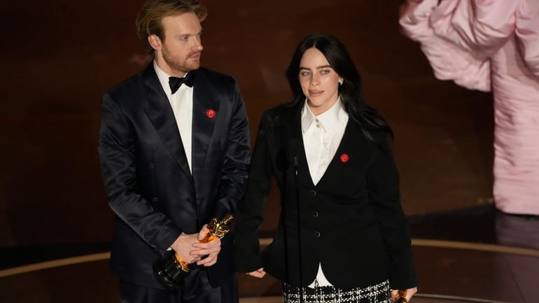Finneas O'Connell, left, and Billie Eilish accept the award for...