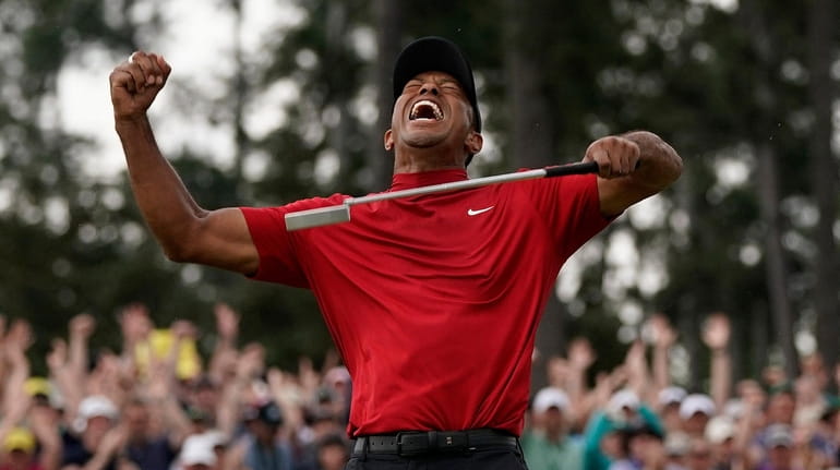 Tiger Woods reacts as he wins the Masters golf tournament...