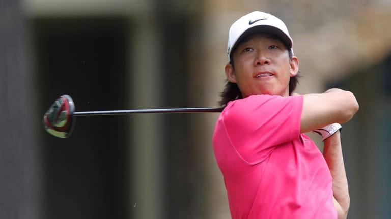 Anthony Kim watches his tee shot on the fourth hole...