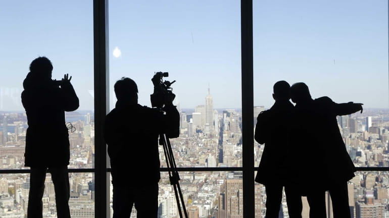 In this file photo, Midtown Manhattan is viewed by visitors...