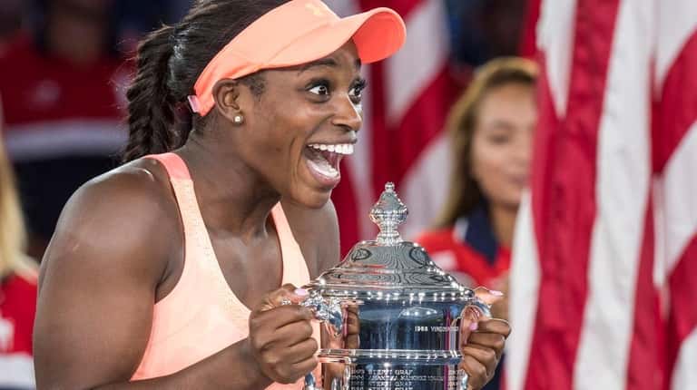 Sloane Stephens reacts upon receiving the trophy after defeating Madison...