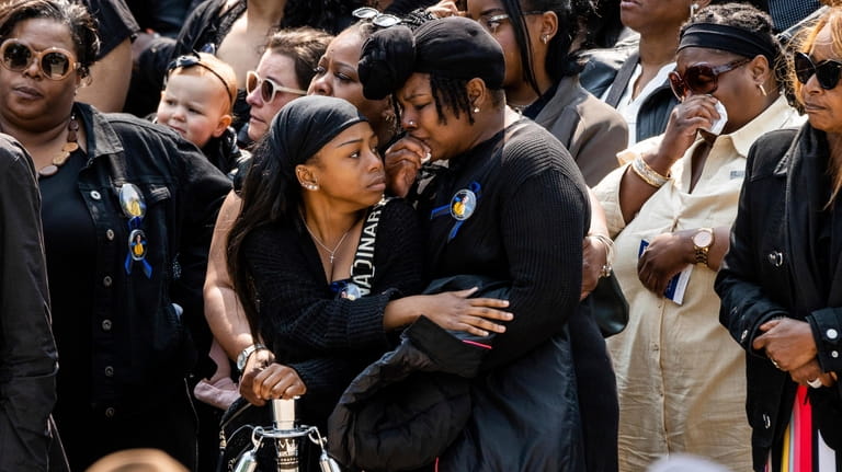 Family and friends of Chicago Officer Aréanah Preston, cry as...