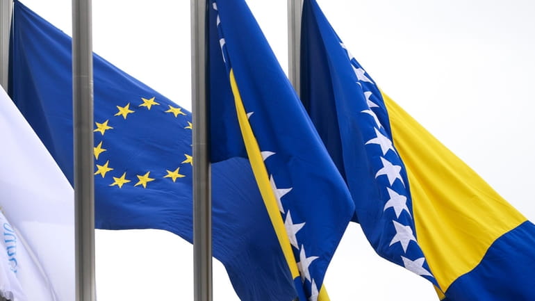 European Union flag flutters next to the flag of Bosnia...