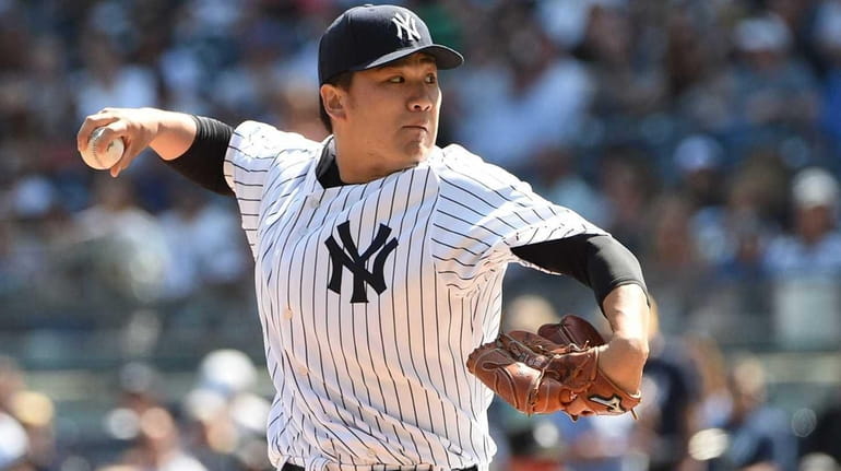 New York Yankees starting pitcher Masahiro Tanaka delivers a pitch...