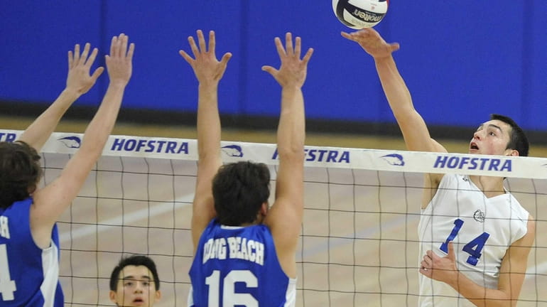 Roslyn's Noah Nardone goes up for a spike during the...