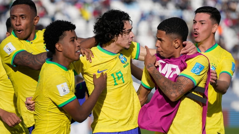 Brazil's Matheus Nascimento, center, celebrates with teammates after scoring his...