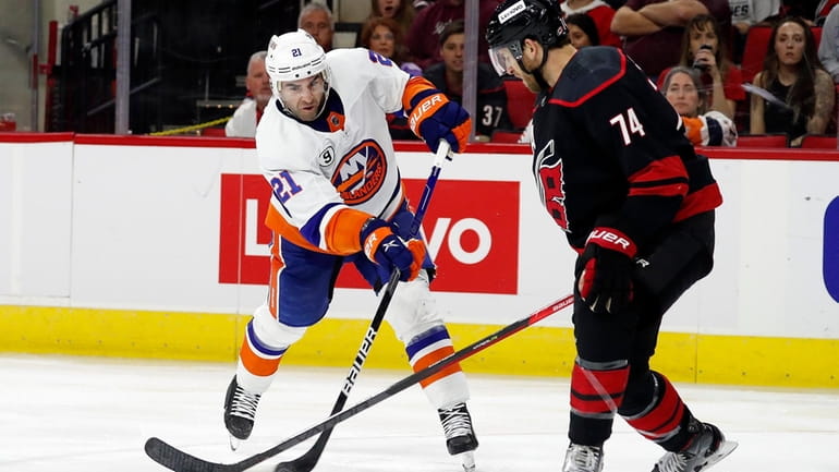 New York Islanders' Kyle Palmieri (21) tries to shoot the...