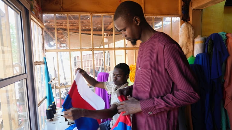 Seamsters make Russian flags in Niamey, Niger, Thursday, Aug. 24,...