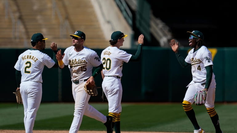 Oakland Athletics right fielder Lawrence Butler, right, celebrates with second...