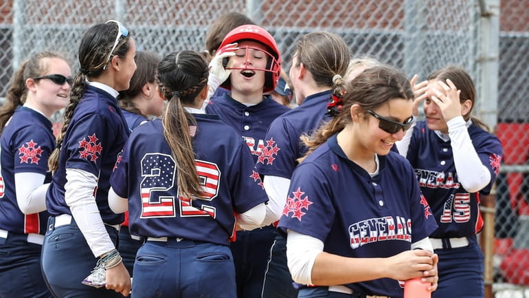 Jessica Mauro, center with helmet, of MacArthur is surrounded at home...