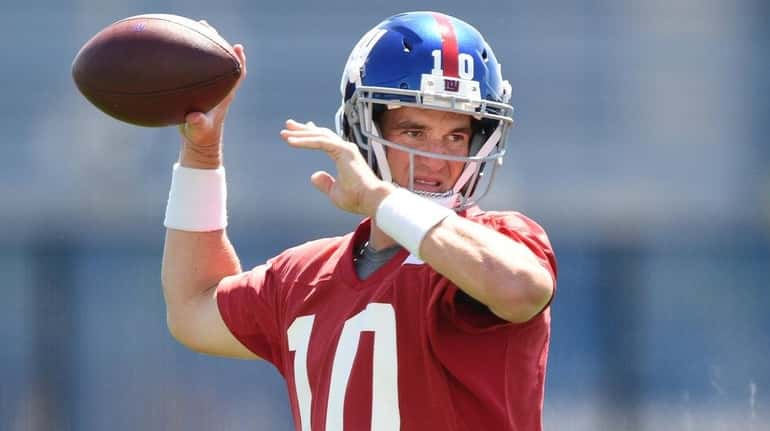 Giants quarterback Eli Manning winds up during OTAs at Quest...