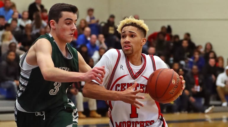 Tyiquon Nix #1 of Center Moriches drives to the basket...