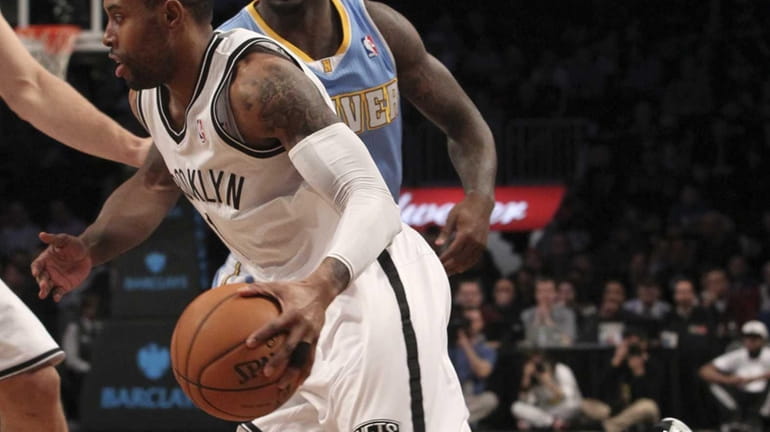 C.J. Watson, foreground, drives past Denver Nuggets guard Ty Lawson...
