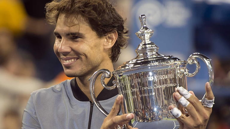 Rafael Nadal holds the winning trophy after defeating Novak Djokovic...