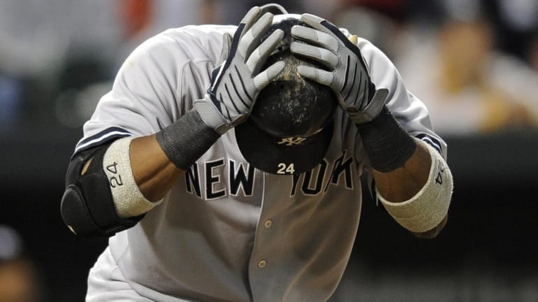 New York Yankees second baseman Robinson Cano reacts after flying...