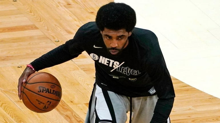 Brooklyn Nets' Kyrie Irving warms up before Game 3 of...