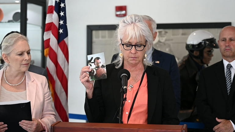 Carole Trottere with a photo of her son, who died...