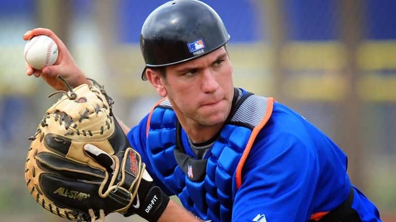 Mets catcher Josh Thole participates in fielding drills during spring...