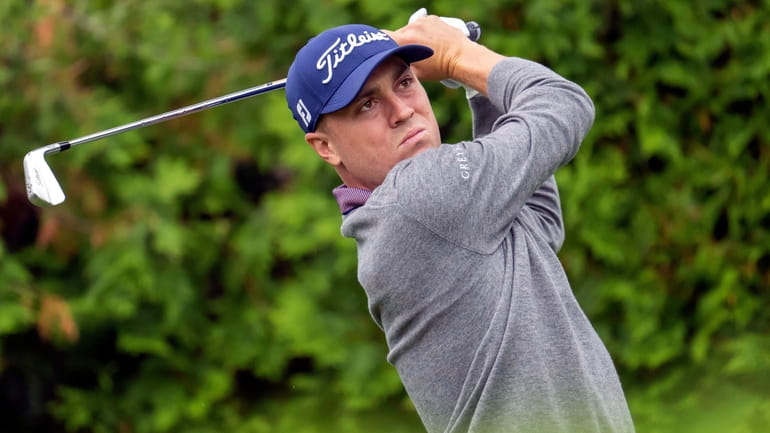 Justin Thomas watches his tee shot on the 13th hole...