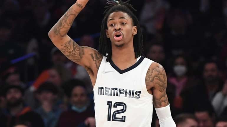 Grizzlies guard Ja Morant directs his teammates in the first...