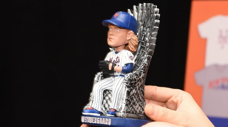 The 2019 Mets Noah Syndergaard bobblehead is presented during a "New...