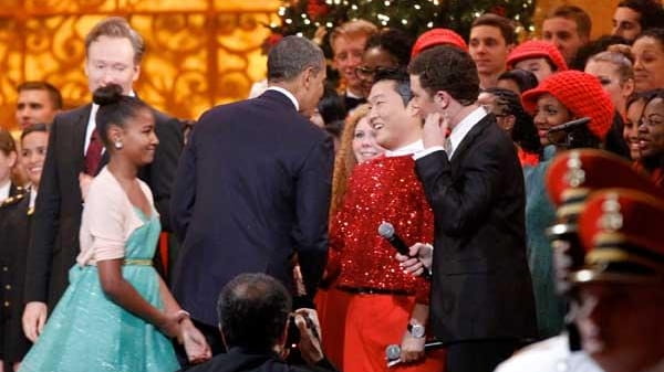 President Barack Obama shakes hands with South Korean musician PSY....