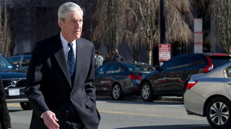 Special counsel Robert Mueller walks to his car after attending...