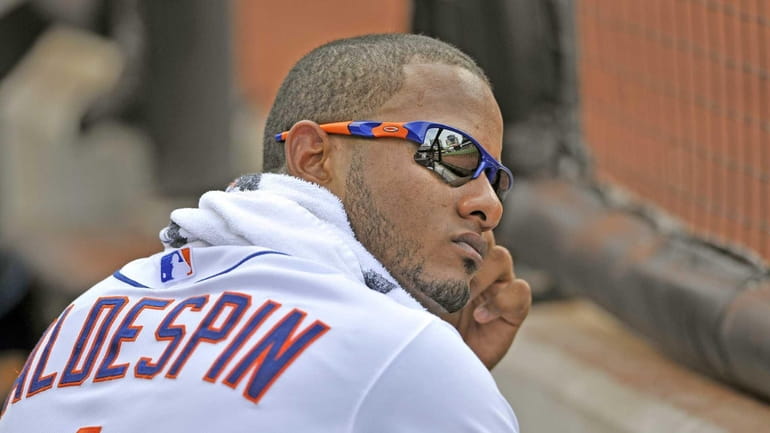 Jordany Valdespin watches the game from the dugout waiting for...