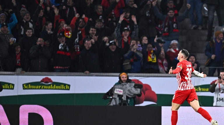 Freiburg's Christian Gunter celebrates after scoring their side's first goal...