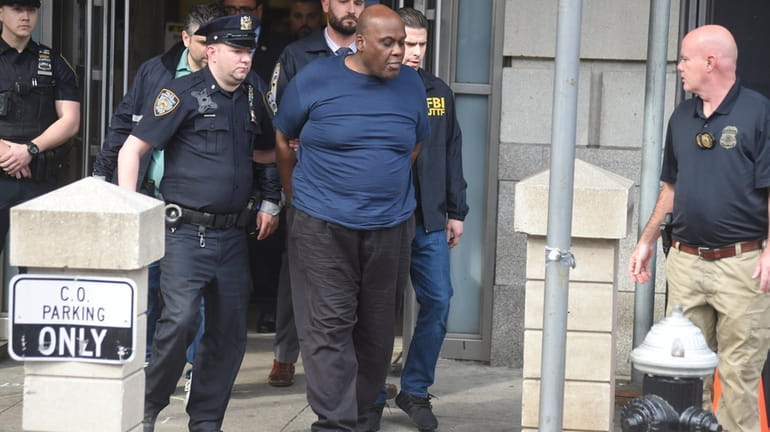 Alleged subway shooter Frank James is led out of the 9th...