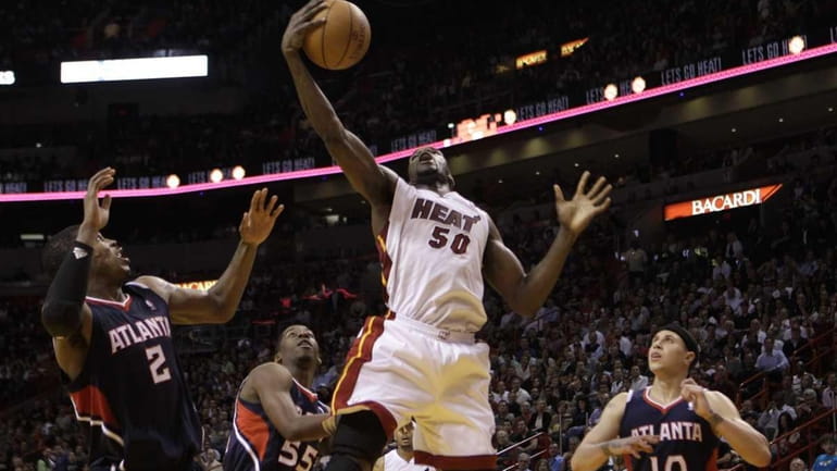 Miami Heat's Joel Anthony (50) grabs a rebound as Atlanta...
