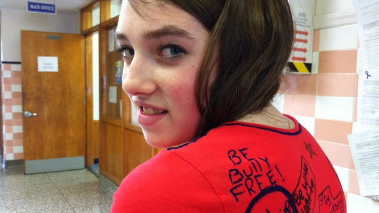 Molly Fritscher, 12, of Calverton, shows off the anti-bullying T-shirt...