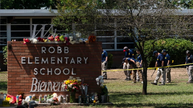 Investigators outside Robb Elementary School in Uvalde, Texas, Wednesday.