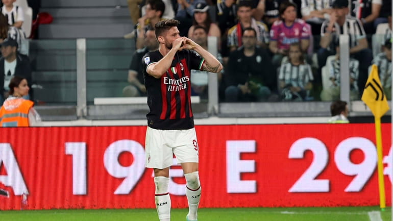 AC Milan's Olivier Giroud celebrates scoring his side's opening goal...