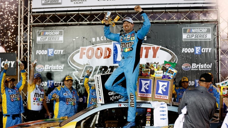 Driver Kyle Busch celebrates after winning a NASCAR Cup Series...