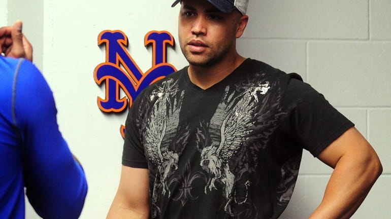 Mets outfielder Carlos Beltran speaks with Jose Reyes in the...