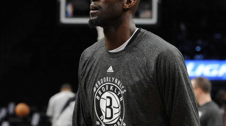 Kevin Garnett looks on from the court during warmups before...
