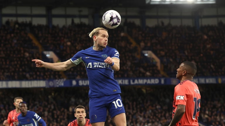 Chelsea's Mykhailo Mudryk heads the ball ahead of Everton's Ashley...