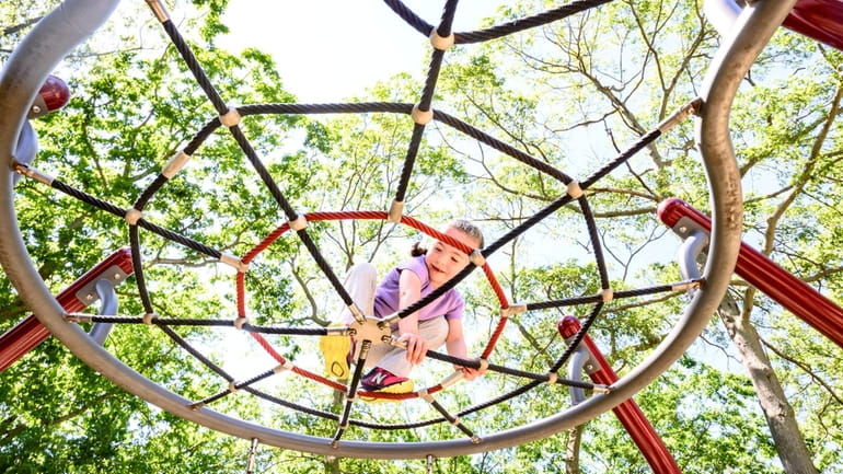 Sophie Pendas of Old Bethpage climbs on the playground at...