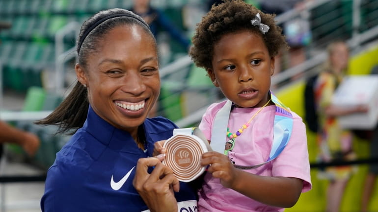 Allyson Felix, of the United States, gives her daughter Camryn...