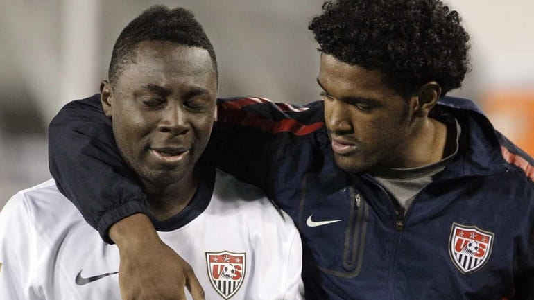 United States' Freddy Adu (7) is consoled as he leaves...