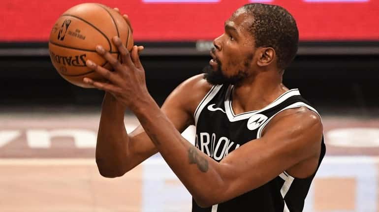 Nets forward Kevin Durant shoots a free throw against the Wizards...