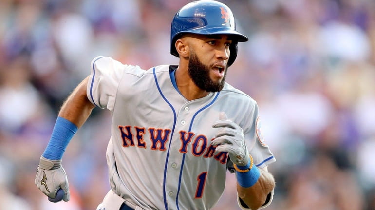 Amed Rosario of the Mets flies out in his first...