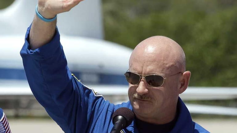 STS-134 Commander Mark Kelly waves to the media after arriving...