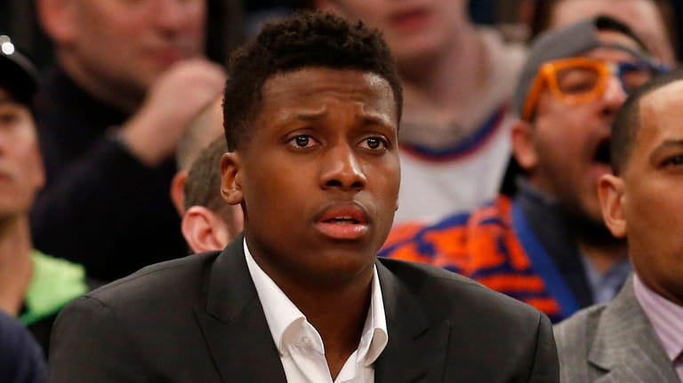 Frank Ntilikina #11 of the Knicks looks on from the bench...